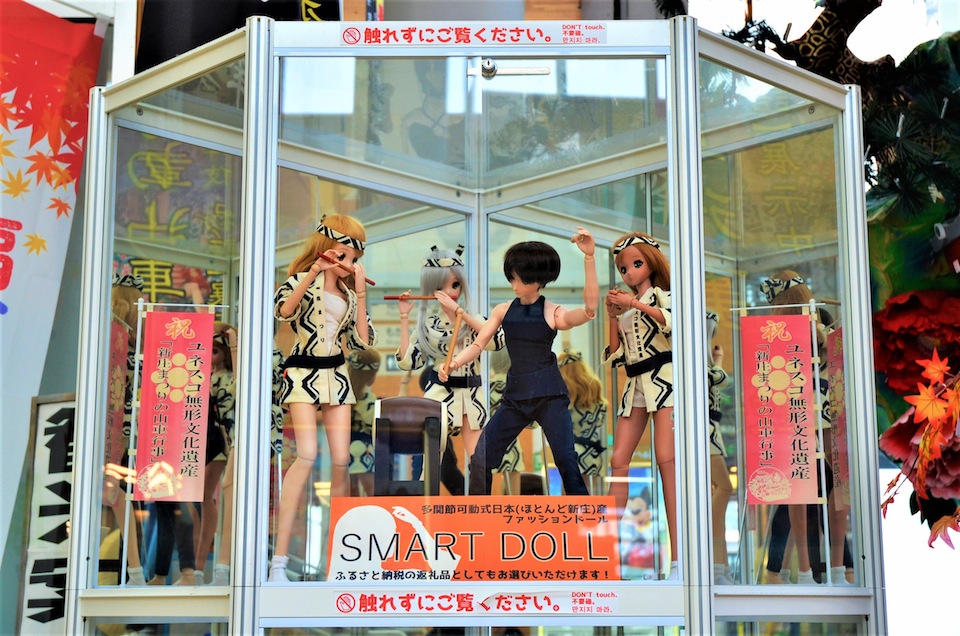 SmartDolls look forward to greeting you at Shinjo Station. Advertising the Shinjo Festival, the iconic annual Shinjo event.